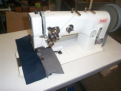 PFAFF Kl. 1244-750/01-900/56 two needle flat bed sewing machine with drop feed and needle feed, large rotary hooks, thread trimmer, extra driven roller presser, complete on table with electronic motor