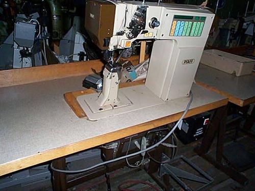 PFAFF Kl. 1491-755/13-900/53 single needle flat post bed sewing machine with wheel feed, needle feed and driven roller presser, thread trimmer, back tacking reverse sewing, right standing post, complete with table and electronic motor